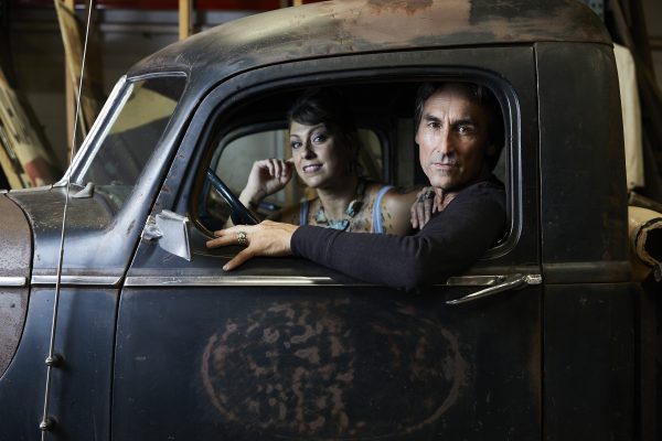 Mike and Danielle in a truck looking out a window